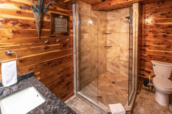 The Waterfall Cabin features a beautifully rustic showerbath.